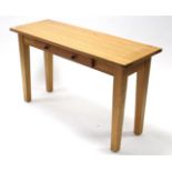 A light-oak finish side table, fitted frieze drawer, & on square tapered legs, 50” wide; together