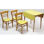 A mid-20th century drop-leaf kitchen table with pale yellow Formica top, & on round tapered legs,