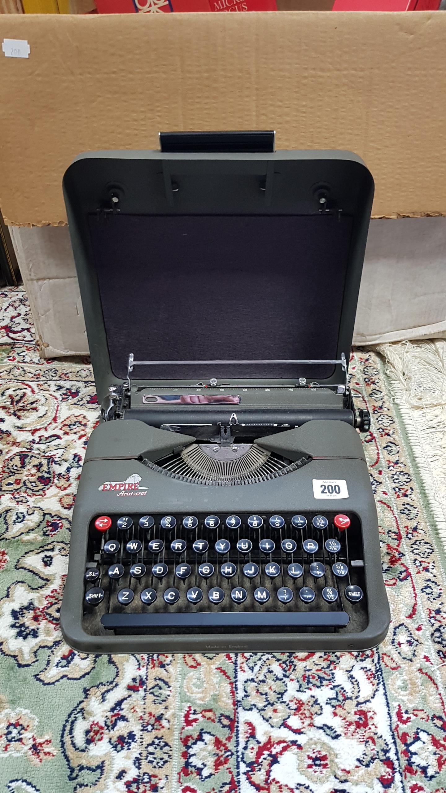 An Empire “Aristocrat” portable typewriter with case; various darkroom accessories, collector’s