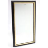 A large rectangular wall mirror in ebonised & gilt frame, & inset bevelled plate, 53¼” x 29”.