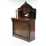 A Victorian mahogany chiffonier, inset rectangular mirror to the low-stage panel back, fitted frieze