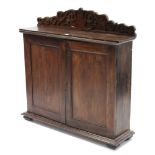 An oak hall cupboard with carved low-stage panel back, fitted two open shelves above two short