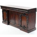 A Victorian mahogany sideboard, (split to top), fitted three cushion-fronted frieze drawers above