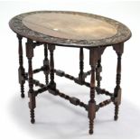 A 19th century carved oak oval gate-leg table on turned supports with turned stretchers, 37” x 25”.