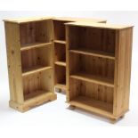 A pine small standing open bookcase with two adjustable shelves, & on shaped plinth base, 24” wide x