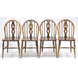 A set of four Ercol elm dining chairs (re-stained), with Prince-of-Wales feather design to the