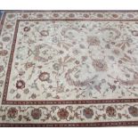 A Kashmiri wool carpet of cream & crimson ground, & with all-over multi-coloured geometric design