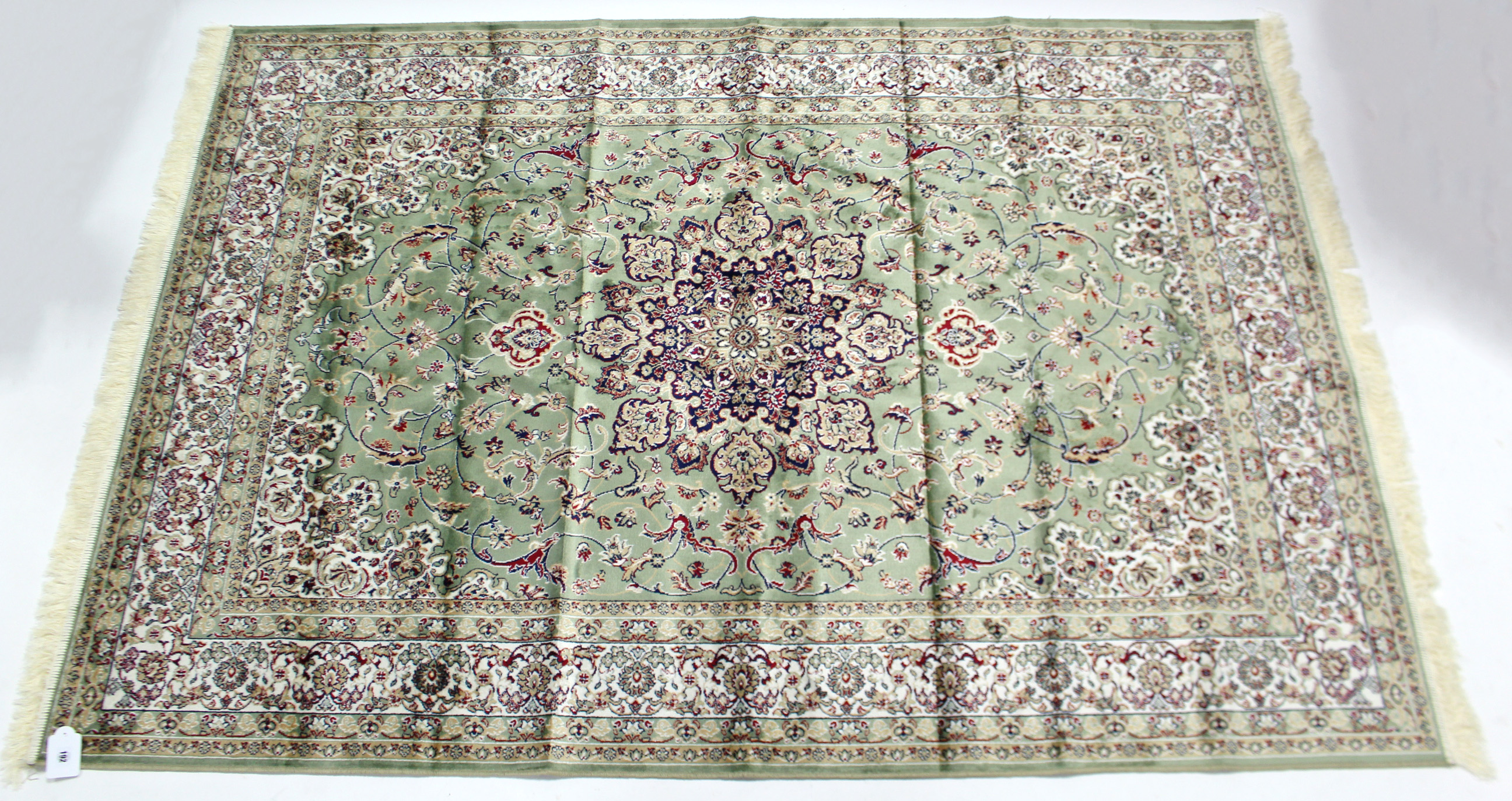 A Keshan small carpet of pale green ground, & with all-over repeating multi-coloured geometric