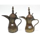 Two Middle Eastern copper coffee pots, 12½” & 11¾” high.