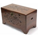 A Chinese teak camphor wood chest with carved dragon design to the hinged lift-lid & front, & on
