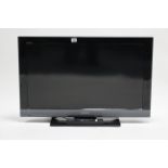 A Sony Bravia 31” LCD television with remote control.