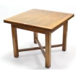 A mid-20th century oak draw-leaf dining table on square chamfered legs with diagonal stretchers, 36”
