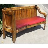A pine corner settle with panelled back, padded drop-in-seat, & on turned & square tapered legs,