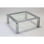 A silvered-metal square coffee table on round legs & inset tempered-glass top, 35½” wide x 14”