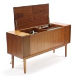 A Bang & Olufsen radiogram in teak case, & on square tapered legs, 53¾” long.
