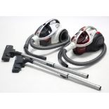 Two Hoover cylinder vacuum cleaners.