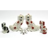 A pair of Staffordshire pottery flat-back seated spaniel ornaments, 12½” high; together with four
