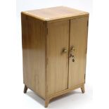 A walnut upright record cabinet, enclosed by pair of panel doors & on shaped plinth base; together