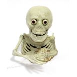 A reproduction painted cast-iron articulated skeleton money bank, 6½” high.