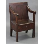 A 19th century pine lambing chair, with panelled back & open scroll arms on chamfered supports,