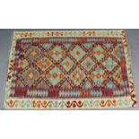 A Choli kelim vegetable-dye rug with multicoloured geometric design; 4’10” x 3’3”.