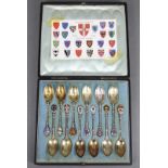 A set of twelve silver & enamel “Cambridge University” teaspoons, the terminal of each with a coat-