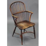 An early 19th century yew, ash, & elm Windsor elbow chair with hooped spindle back, curved arms, &