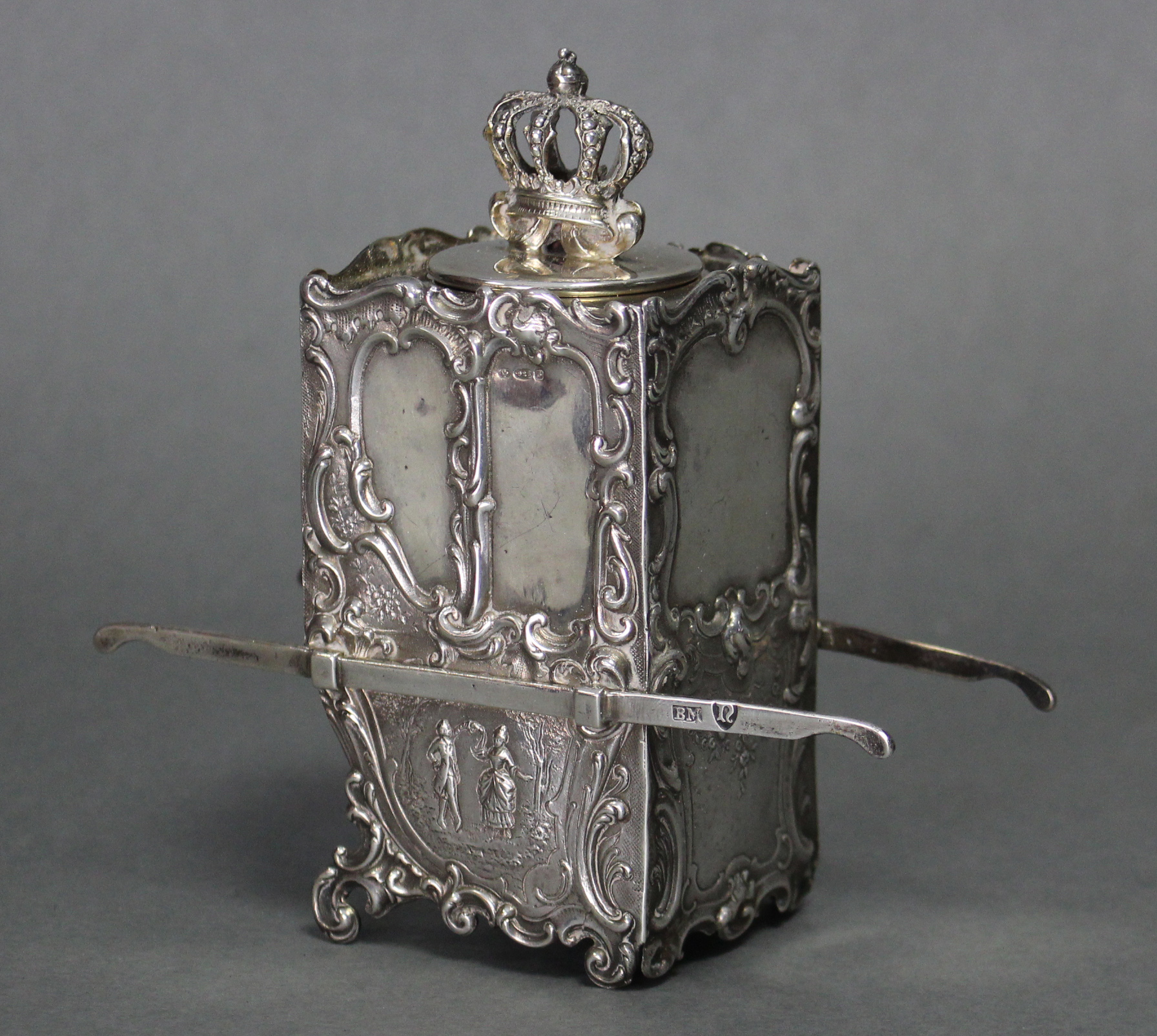 A continental silver tea caddy in the form of a sedan chair, with all-over embossed decoration, a