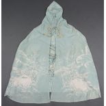 A Japanese pale blue/green silk hooded gown with embroidered landscape decoration in white silk.