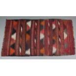 A Kelim rug of of crimson ground, 74" x 40" (worn); & a Bokhara small runner, 72" x 25.5" (worn).