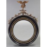 A REGENCY EBONISED & GILT-GESSO FRAME LARGE CONVEX WALL MIRROR, with eagle crest & husk-swag