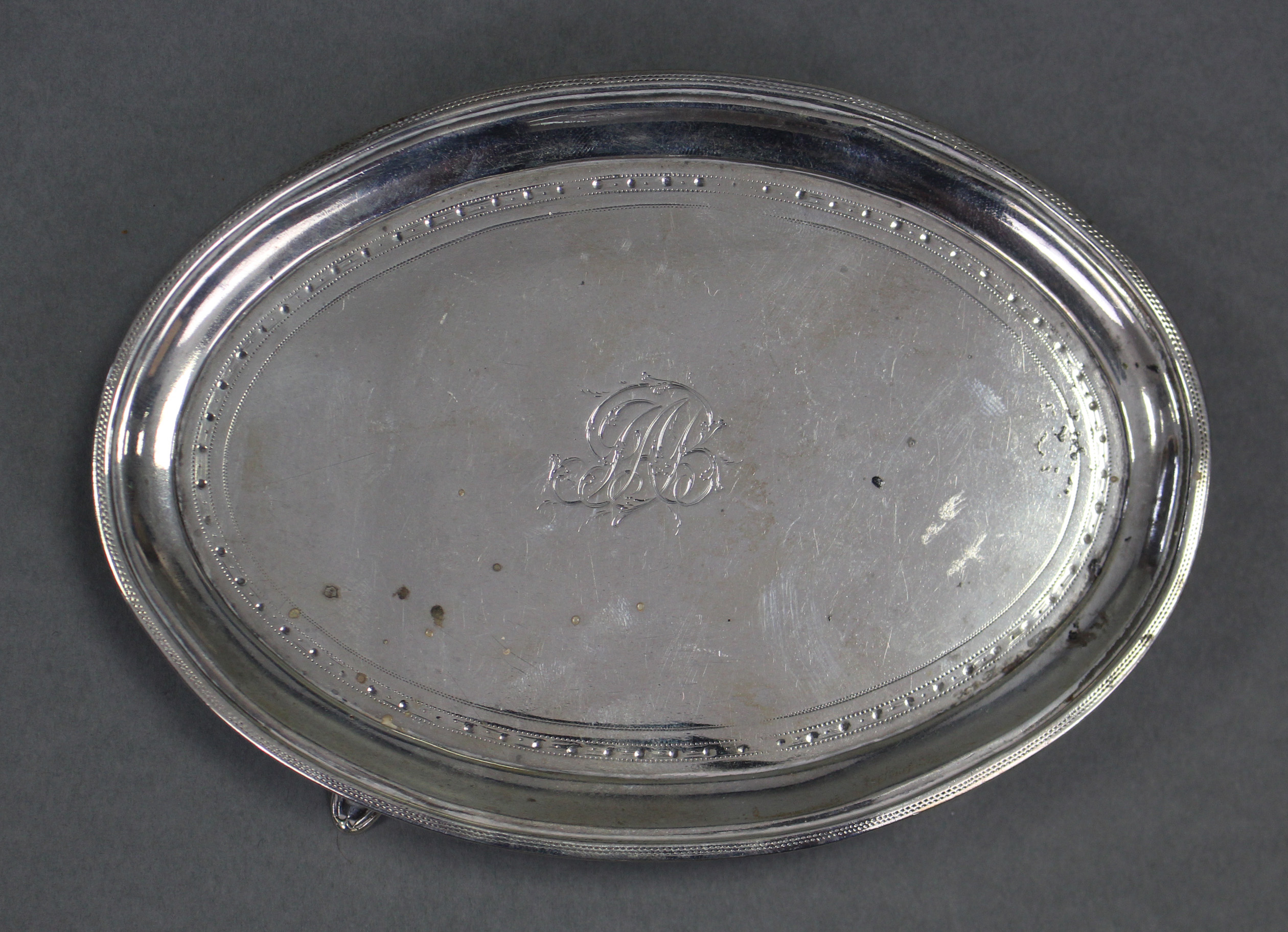 A George III silver oval teapot stand with pricked borders, engraved monogram to centre, & on four - Image 2 of 3