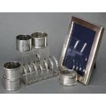 A George V silver six-division toast rack, Birmingham 1932; five various napkin rings; & a modern
