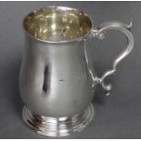 An early George III silver baluster mug with acanthus scroll handle, on raised circular foot, 5¾”