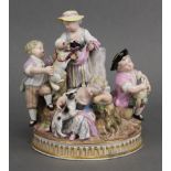 A MEISSEN PASTORAL GROUP of three female & two male figures about a central truncated column, one