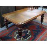 A VICTORIAN EXTENDING DINING TABLE with wind-out action, moulded edge to the rectangular top & heavy