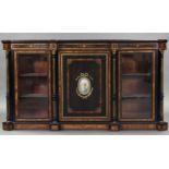 A MID-VICTORIAN EBONISED, AMBOYNA, & ORMOLU-MOUNTED CREDENZA, the central panel door inset Sevres