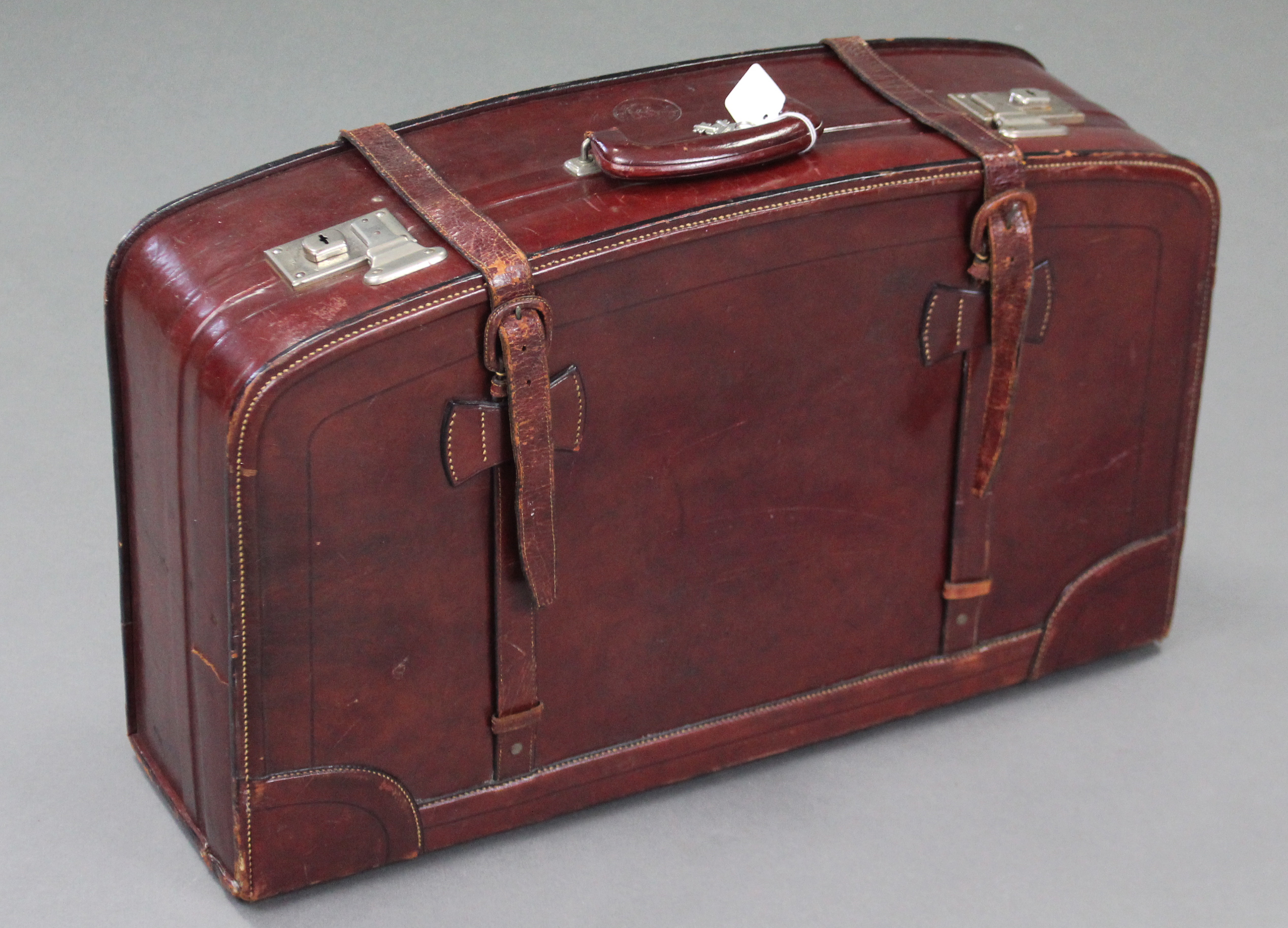 A Chinese “Rhinocerous” brand brown leather large suitcase by the Fook Seng Company.