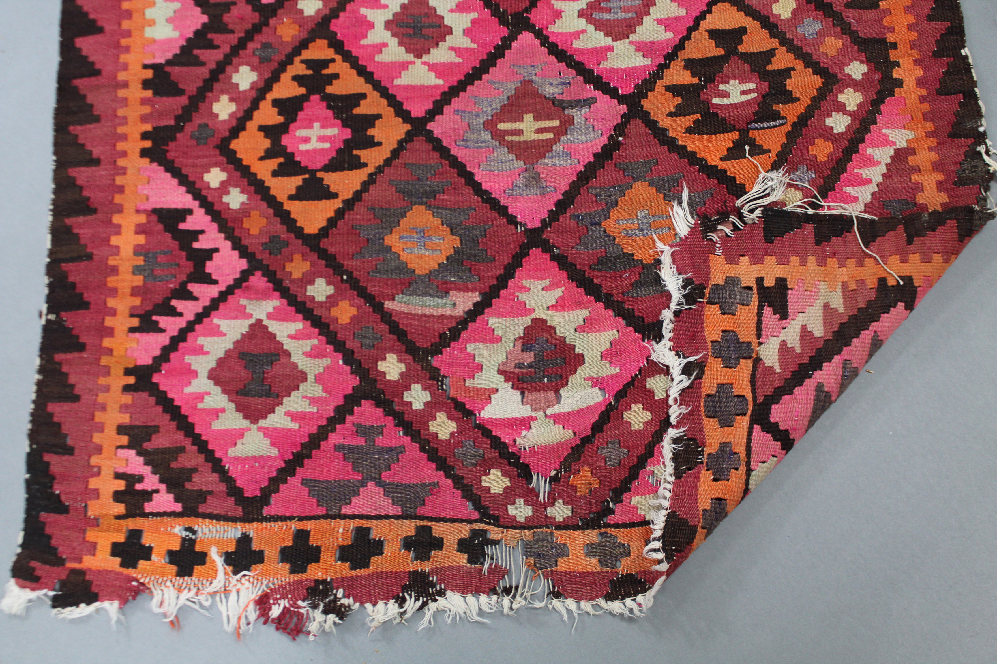 A Kelim runner of pink ground, with all-over geometric lozenge design; 11’ x 3’ 4” (worn). - Image 2 of 2