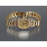 A “Q” ladies’ wristwatch in 9ct. gold case, the cushion-shaped champagne dial with gold baton