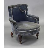 A Victorian tub-shaped low ladies’ armchair upholstered blue velour with silk trim, buttoned arms,