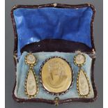 A 19th century Italian lava oval brooch carved in high relief with a classical female bust, together