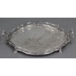 An Edwardian silver-plated shaped oval two-handled tray with embossed decoration of a bird amongst