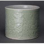 A Chinese porcelain carved celadon brush pot with decoration of dragons amongst lingzhi & trailing