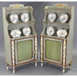 A PAIR OF REGENCY STYLE PAINTED WATERFALL BOOKCASES, each with ram’s head & leaf-sprays to the