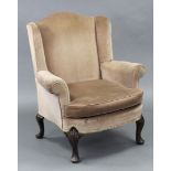 A mid-18th century style upholstered armchair on four mahogany cabriole legs, the fluted front
