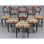 A set of six William IV rosewood dining chairs with heavily carved kidney-shaped backs, padded seats