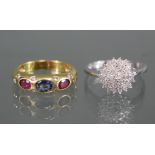 A yellow metal ring set oval sapphire & two oval rubies with pairs of small diamonds in between &