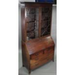 A George III mahogany bureau bookcase, the upper part with cavetto cornice & fitted three adjustable