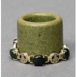 A Chinese gilt-metal bracelet set six cabochon-cut green hardstones intersected by pierced roundels,